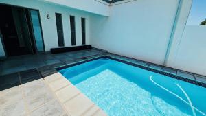 a small blue swimming pool in front of a building at Bluebay Villa in Britannia Bay