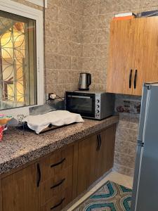 a kitchen with a counter top with a microwave at Zinat outdoor villa in Tétouan