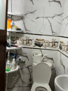 a bathroom with a toilet and a sink at Zinat outdoor villa in Tétouan