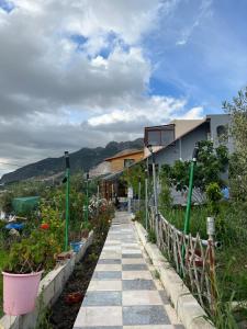 a walkway in front of a house with flowers at Zinat outdoor villa in Tétouan