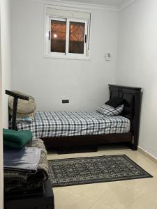 a couch sitting in a room with a window at Zinat outdoor villa in Tétouan