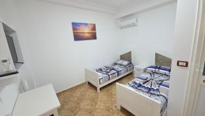 a room with two beds and a tv in it at Hotel Reci in Peshkopi