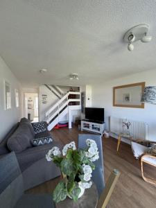 a living room with a couch and a table at 34 Surfview Beach House in Newquay