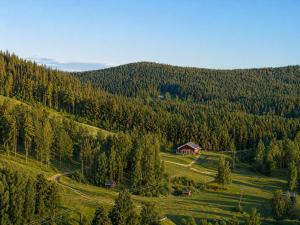 a house on the side of a hill with trees at Mukka Mountain in Ruskola