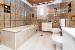 a bathroom with a tub and a toilet and a sink at Enjoy & Relax Da Elvia in Rovinj +22 photos