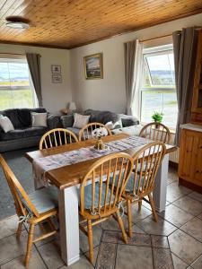 a living room with a wooden table and chairs at Sonnys Rest in Ardara +40 photos