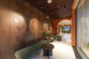 a lobby with a wall of circles on the wall at Soluna Dalat Hotel in Da Lat