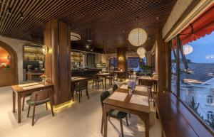a restaurant with tables and chairs and a bar at Soluna Dalat Hotel in Da Lat