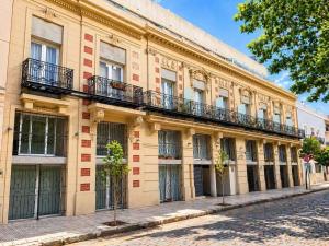 a building with balconies on the side of a street at Lezama Park in Buenos Aires