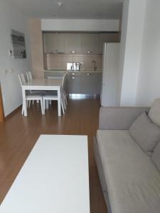 a living room with a couch and a table and a kitchen at Bahía Serena in Roquetas de Mar