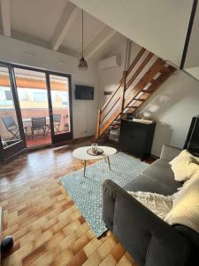 a living room with a couch and a table at Vacances Cap d'Agde 1 chambre, 1 mezzanine, parking et piscine in Cap d'Agde