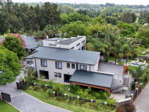 an aerial view of a white house with trees at Pitzer Suites in Midrand