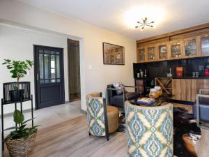 a living room with a couch and a table at Pitzer Suites in Midrand