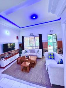 a living room with a couch and a table at Eva Residence Arusha in Arusha