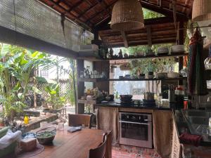 a kitchen with a wooden table and a counter top at mehome Hidden Garden Homestay in Cư Chinh