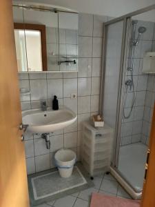 a bathroom with a sink and a shower and a toilet at Pension Hutterer in Scharnstein +34 photos