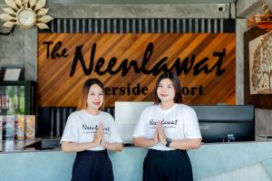 two girls are standing in front of a counter with their hands in front at Neenlawat Riverside in Suratthani +86 photos