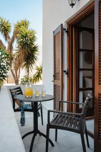 a table and chairs on a patio with a table at Katerina Studios in Naxos Chora