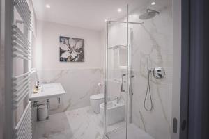 a bathroom with a shower and a toilet and a sink at CuorNice - LG Estate in Ripe San Ginesio +19 photos