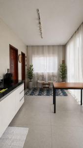 a kitchen with a table and chairs in a room at Chalé Arandu in Santo Amaro