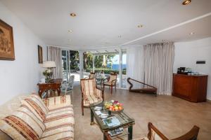 a living room with a couch and a table at Grand Hotel Del Mare Resort & Spa in Bordighera