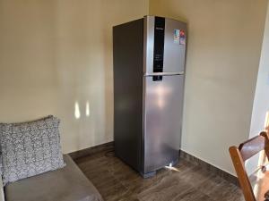 a refrigerator in the corner of a room at Chalés Refúgio da Sil 2 in Cavalcante