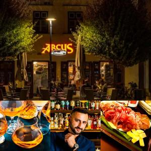 a man is sitting at a bar with food at Sicomoro Casa in Sopron