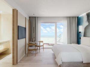 a bedroom with a bed and a table with chairs at Hotel Emilia in Ancona +76 photos