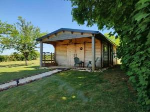 a shed with a table and chairs in a yard at l'Eden du sancerrois in Sens-Beaujeu