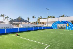 a tennis court with a tennis ball on the court at VIVA Eden Lago in Port d'Alcudia +52 photos