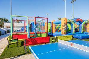 a playground with a table tennis court in front of it at VIVA Eden Lago in Port d'Alcudia