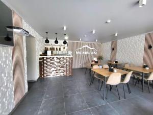 a restaurant with tables and chairs and a counter at Отель MONBLAN in Yablunytsya