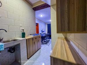 a kitchen with a sink and a counter top at Speke homes full apartment!!! in Kabale +2 photos