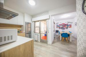 a kitchen with a table and a dining room at Villa Artista home in Pontevedra