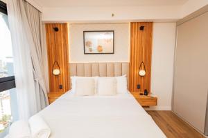 a bedroom with a large white bed with white pillows at Stylish Luxury Apartment - Fully Equipped in Asunción