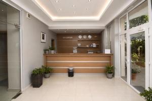 a lobby with a waiting area with plants at HOTEL BRIZ - Free Parking in Burgas