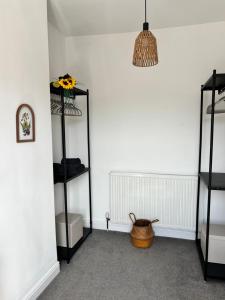 a room with two shelves and a basket at Peak Retreat in Chesterfield