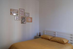 a bedroom with a bed and pictures on the wall at Amati Bed & Breakfast in Lecce