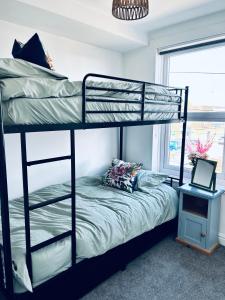 a bedroom with two bunk beds and a laptop on a table at Peak Retreat in Chesterfield