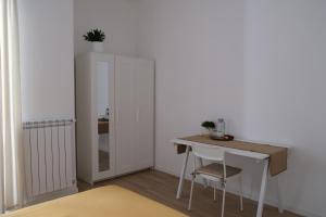 a room with a desk and a table with a plant on top at Amati Bed & Breakfast in Lecce