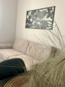 a living room with a couch and a plant at Mabys home in Chalkida