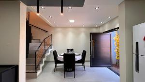 a dining room with a table and chairs and a staircase at Sobrado inteligente, A C, TVs Smart e garagem in Toledo