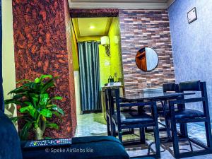 a dining room with a table and some chairs at Speke homes full apartment!!! in Kabale