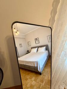 a mirror reflection of a bed in a bedroom at Mabys home in Chalkida