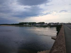 a view of a river with a cloudy sky at Maison Angers bord de loire, rue Jules Quelin in Les Ponts-de-Cé