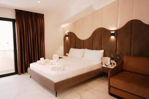 a hotel room with a bed and a chair at Villa SOLIS in Vlorë