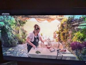 a woman preparing food on top of a table at Rosa B&B in Lin