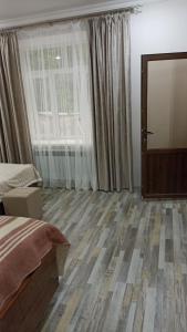 a bedroom with a bed and a large window at Bnakaran dzoragetum in Dzoraget