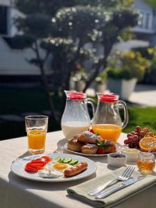 a table with breakfast foods and drinks on it at Villa SOLIS in Vlorë +76 photos