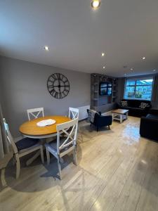 a dining room with a table and chairs and a living room at Caol Mountain View in Caol